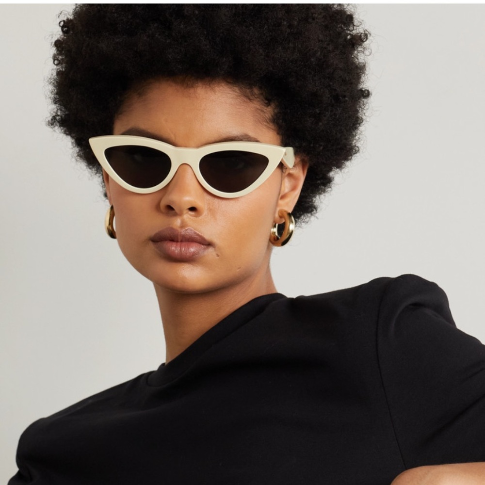 CELINE Eyewear's cat-eye pair is made from ivory acetate with solid lenses.